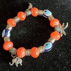 Silvertone, orange beaded stretch bracelet, charms